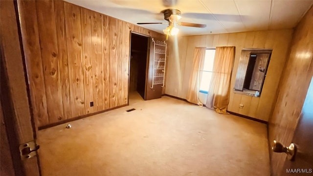610 Booth Rd, Montgomery, AL 36108 - unfurnished bedroom with wooden walls, baseboards, carpet floors, and a ceiling fan