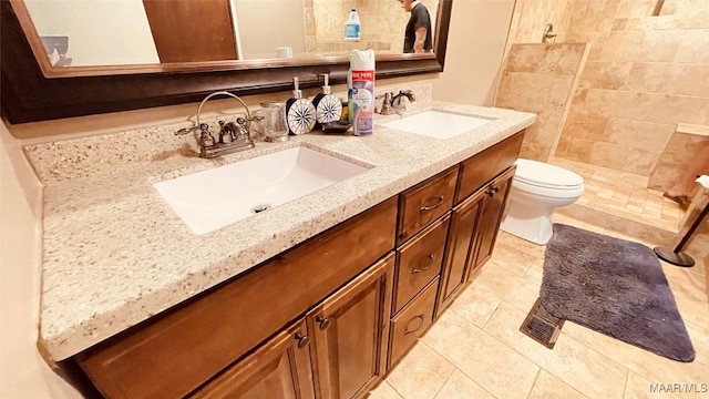 610 Booth Rd, Montgomery, AL 36108 - full bath with double vanity, toilet, tile patterned floors, and tiled shower