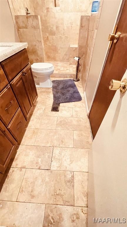 610 Booth Rd, Montgomery, AL 36108 - full bathroom featuring vanity, toilet, a tile shower, and tile patterned floors