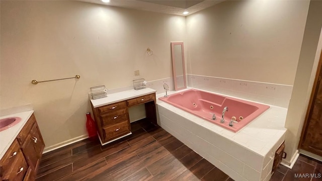 610 Booth Rd, Montgomery, AL 36108 - bathroom featuring vanity, a whirlpool tub, and wood finished floors