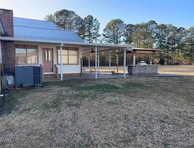 610 Booth Rd, Montgomery, AL 36108 - view of grassy yard featuring an attached carport, central air condition unit, and ceiling fan