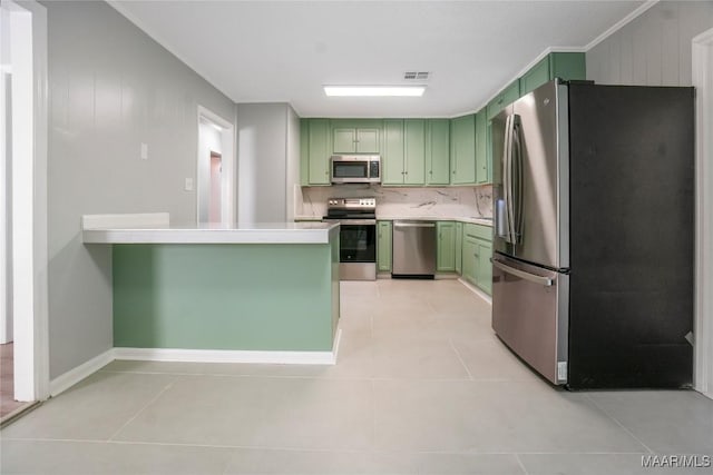 5736 Roxboro Dr, Montgomery, AL 36117 - kitchen featuring green cabinets, stainless steel appliances, light tile patterned flooring, light countertops, and decorative backsplash