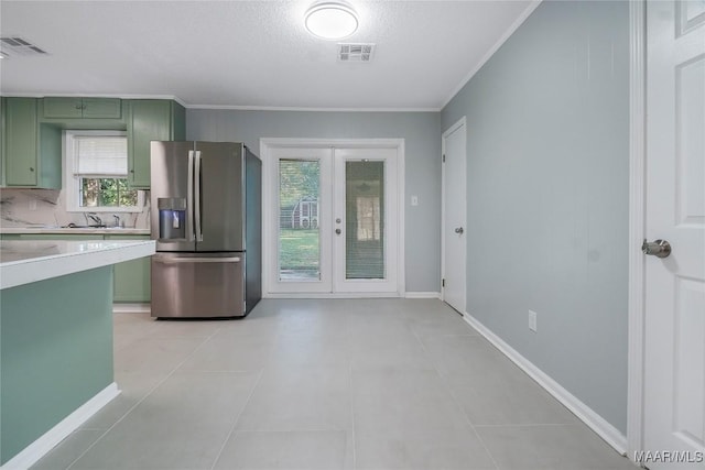 5736 Roxboro Dr, Montgomery, AL 36117 - kitchen with green cabinets, stainless steel fridge, french doors, light countertops, and ornamental molding