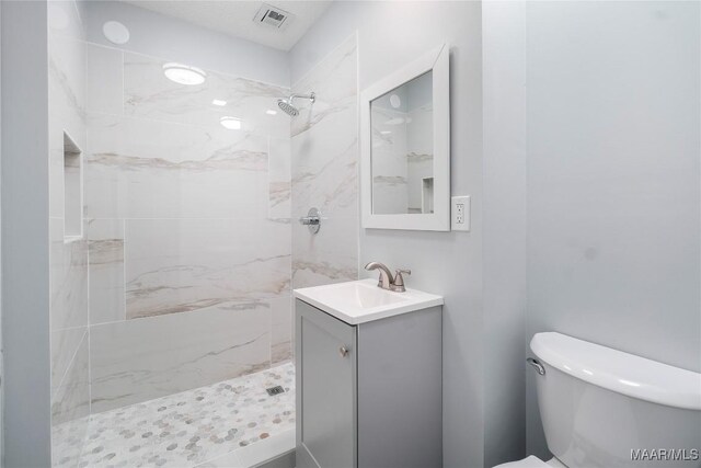 5736 Roxboro Dr, Montgomery, AL 36117 - bathroom with vanity, a marble finish shower, and toilet