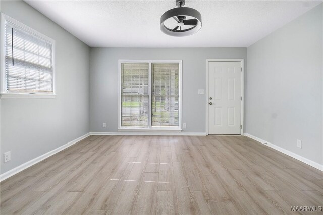 5736 Roxboro Dr, Montgomery, AL 36117 - empty room featuring light wood finished floors, baseboards, a textured ceiling, and a ceiling fan