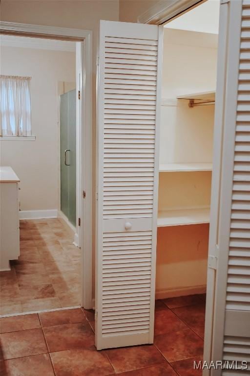 813 Lake Region Cir, Wetumpka, AL 36092 - bathroom with a closet, tile patterned flooring, vanity, a stall shower, and baseboards
