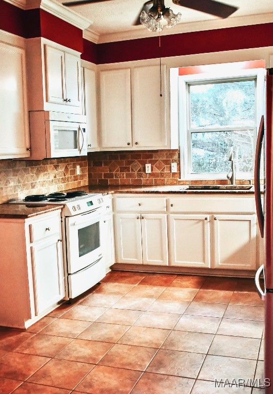 813 Lake Region Cir, Wetumpka, AL 36092 - kitchen featuring white appliances, ornamental molding, a sink, tasteful backsplash, and light tile patterned floors