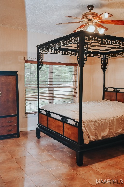 813 Lake Region Cir, Wetumpka, AL 36092 - bedroom with tile patterned floors, a textured ceiling, ornamental molding, and baseboards