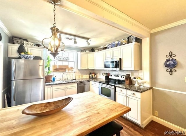1915 Mckinley Ave, Montgomery, AL 36107 - kitchen featuring appliances with stainless steel finishes, a sink, ornamental molding, tasteful backsplash, and dark wood-style floors