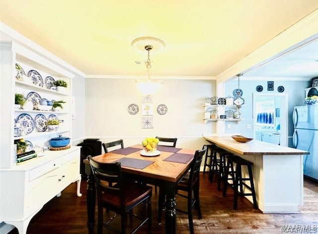 1915 Mckinley Ave, Montgomery, AL 36107 - dining space featuring dark wood-type flooring, crown molding, and independent washer and dryer