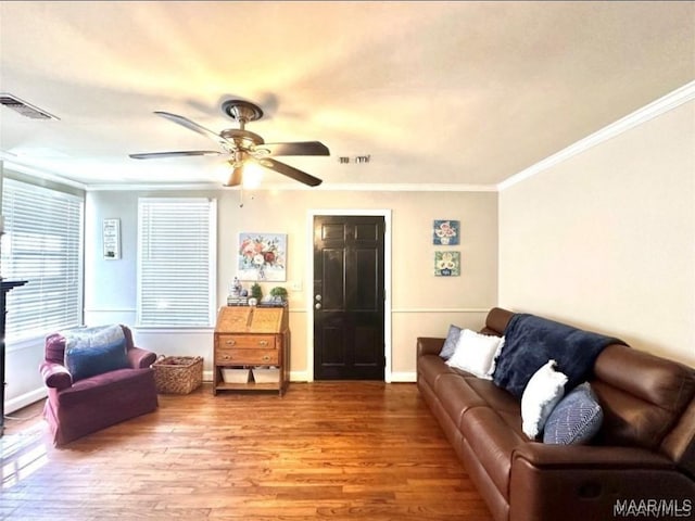 1915 Mckinley Ave, Montgomery, AL 36107 - living area featuring wood finished floors, crown molding, ceiling fan, and baseboards