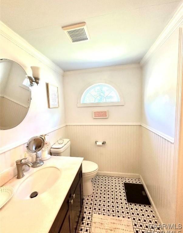 1915 Mckinley Ave, Montgomery, AL 36107 - bathroom featuring toilet, wainscoting, vanity, tile patterned floors, and crown molding
