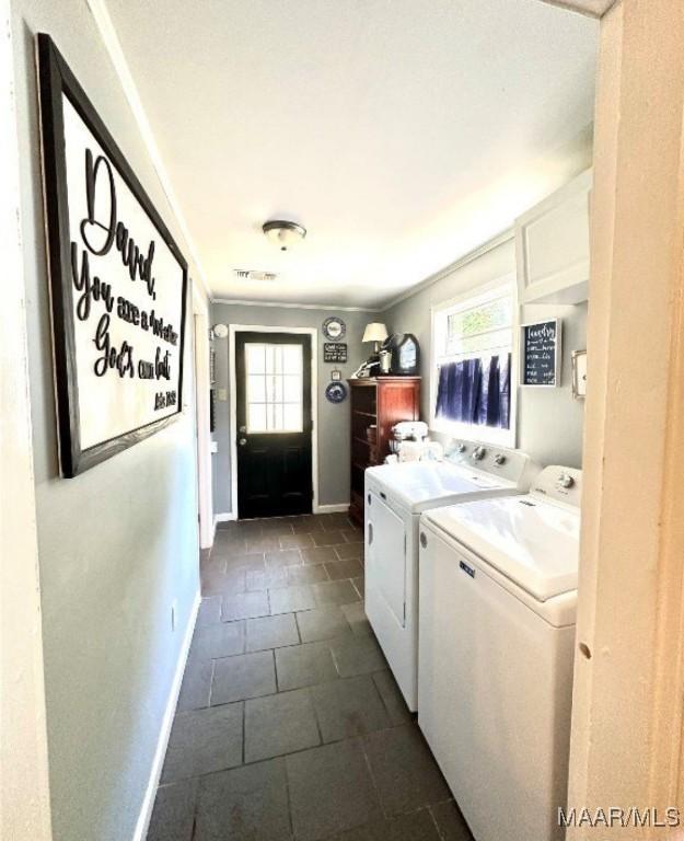 1915 Mckinley Ave, Montgomery, AL 36107 - laundry room with independent washer and dryer, baseboards, and dark tile patterned flooring