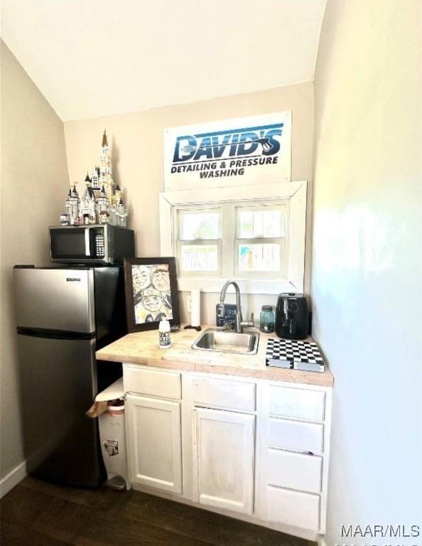 1915 Mckinley Ave, Montgomery, AL 36107 - bar with freestanding refrigerator, a sink, vaulted ceiling, and dark wood finished floors