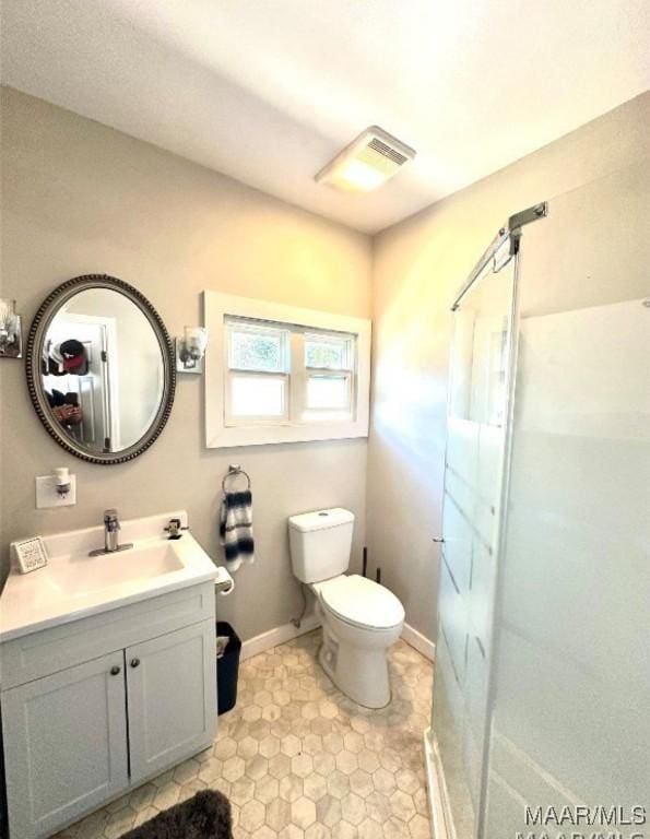 1915 Mckinley Ave, Montgomery, AL 36107 - bathroom with vanity, a shower stall, toilet, and baseboards
