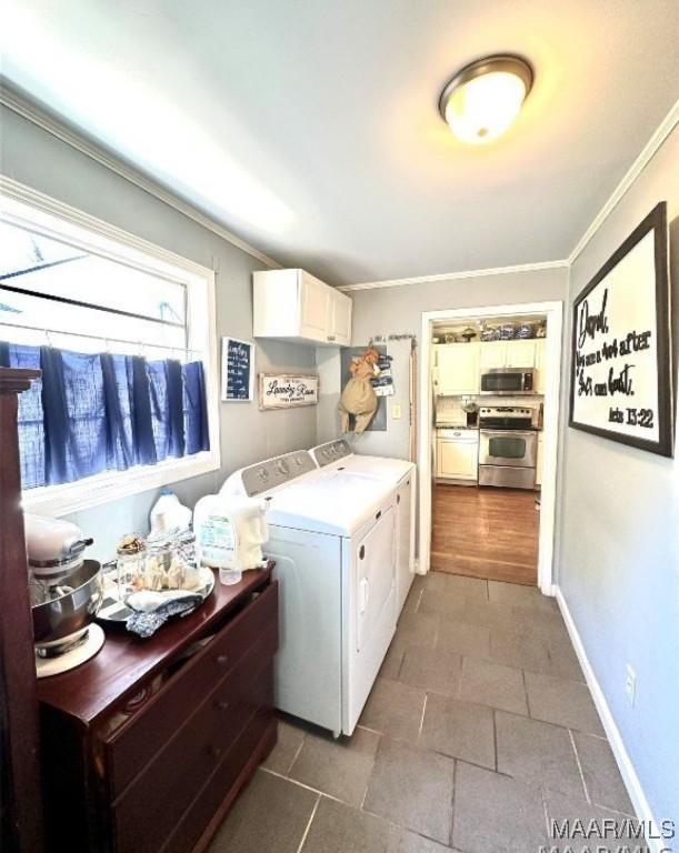 1915 Mckinley Ave, Montgomery, AL 36107 - washroom with washer and clothes dryer, ornamental molding, and cabinet space
