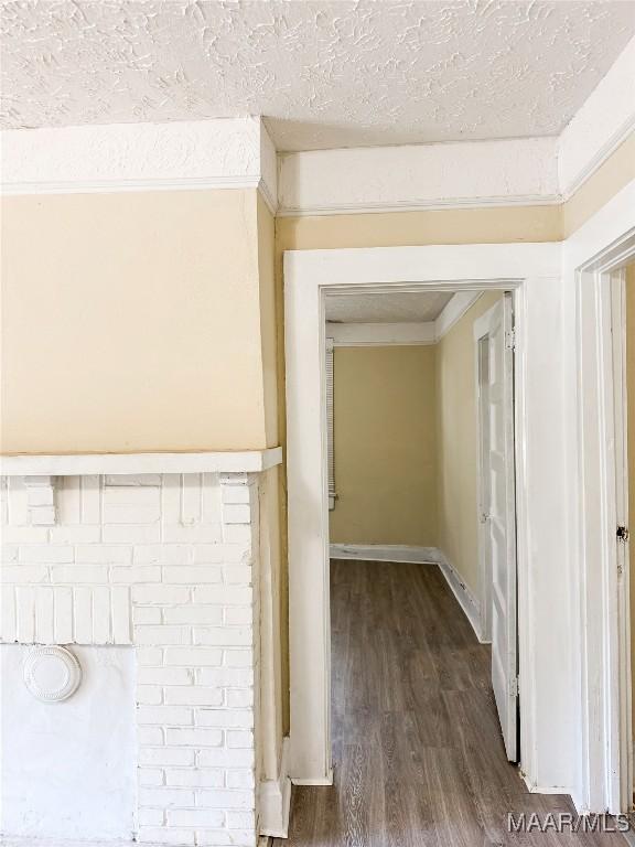 1422 S Holt St, Montgomery, AL 36108 - hall featuring dark wood finished floors and a textured ceiling