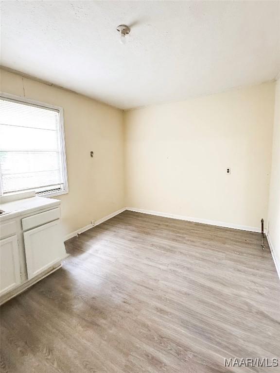 1422 S Holt St, Montgomery, AL 36108 - unfurnished room with light wood-style floors and baseboards