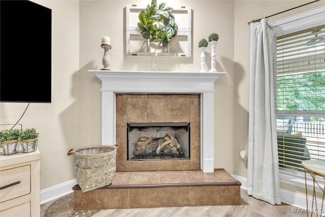 190 Sherwood Trl, Wetumpka, AL 36093 - detailed view of baseboards, a tiled fireplace, and wood finished floors