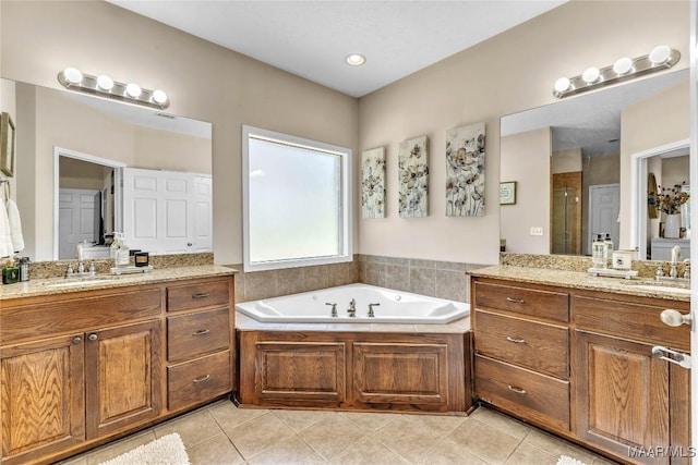 190 Sherwood Trl, Wetumpka, AL 36093 - bathroom featuring a stall shower, two vanities, tile patterned flooring, and a bath