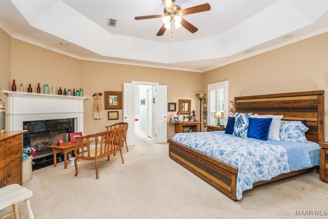 8054 Lakeridge Dr, Montgomery, AL 36117 - bedroom with a tray ceiling, light carpet, a fireplace, ornamental molding, and a ceiling fan