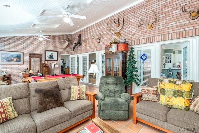8054 Lakeridge Dr, Montgomery, AL 36117 - tiled living area with brick wall, ceiling fan, a skylight, high vaulted ceiling, and billiards table