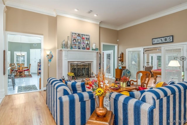 8054 Lakeridge Dr, Montgomery, AL 36117 - living room featuring crown molding, wood finished floors, a fireplace, a chandelier, and baseboards
