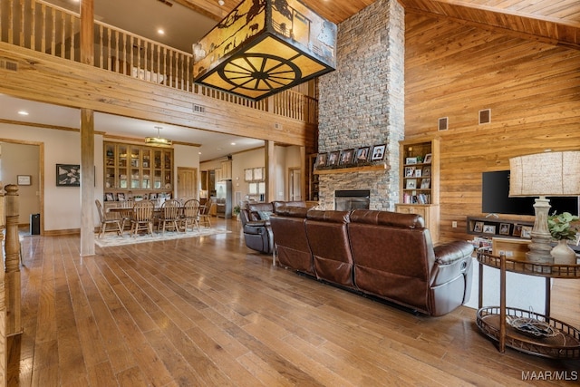 511 Mehearg Rd, Wetumpka, AL 36092 - living area with a high ceiling, wood walls, a stone fireplace, and wood finished floors