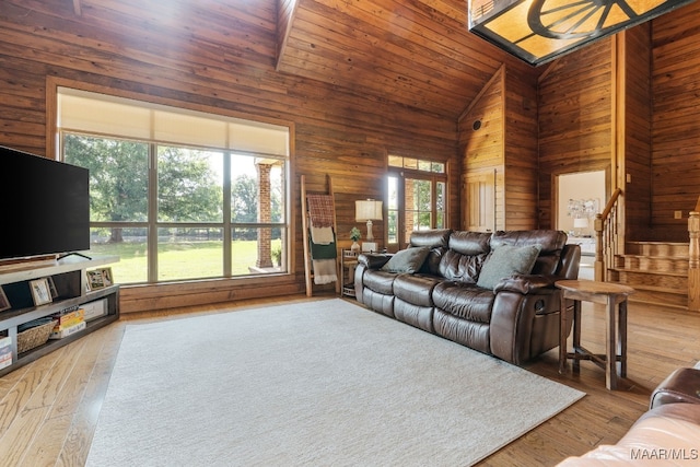 511 Mehearg Rd, Wetumpka, AL 36092 - living area featuring high vaulted ceiling, wooden walls, stairway, and wood finished floors