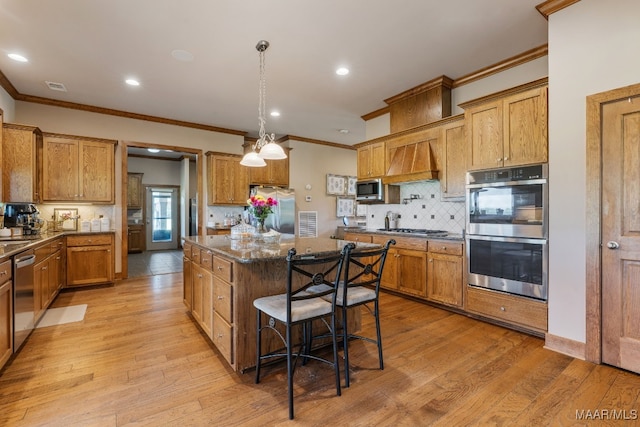511 Mehearg Rd, Wetumpka, AL 36092 - kitchen featuring stainless steel appliances, ornamental molding, a center island, custom range hood, and tasteful backsplash