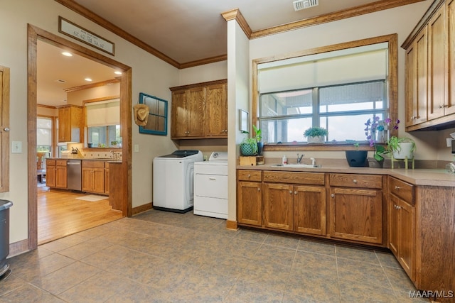511 Mehearg Rd, Wetumpka, AL 36092 - laundry room with independent washer and dryer, cabinet space, ornamental molding, and dark tile patterned floors