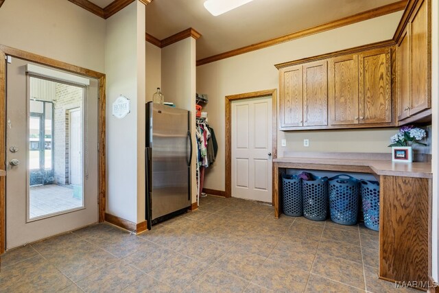 511 Mehearg Rd, Wetumpka, AL 36092 - kitchen with freestanding refrigerator, ornamental molding, light countertops, tile patterned flooring, and brown cabinets