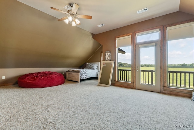 511 Mehearg Rd, Wetumpka, AL 36092 - carpeted bedroom featuring lofted ceiling, access to exterior, multiple windows, and ceiling fan
