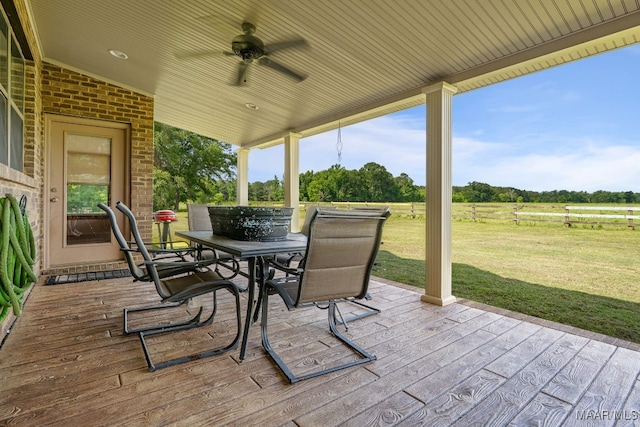 511 Mehearg Rd, Wetumpka, AL 36092 - view of patio featuring a wooden deck, a ceiling fan, outdoor dining area, and a rural view