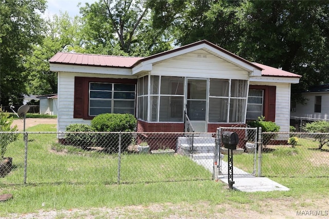2612 Harris St, Selma, AL 36701 - view of front of home with a sunroom, a gate, and metal roof