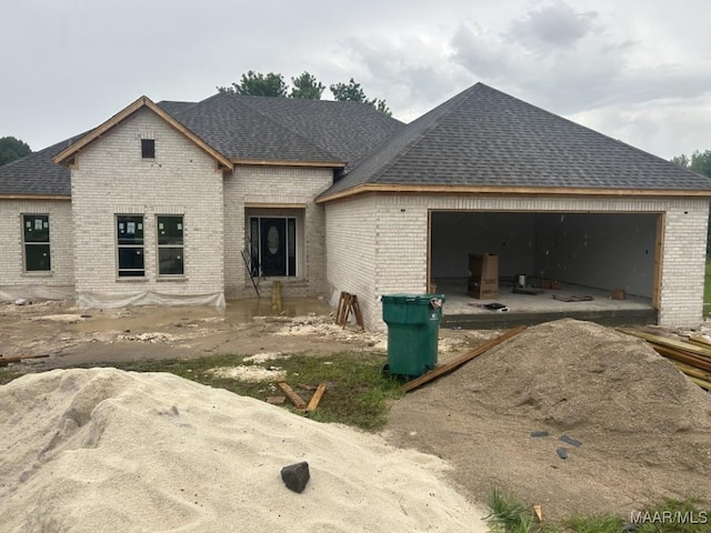 63 Noles Rd, Tallassee, AL 36078 - view of front facade with brick siding, an attached garage, driveway, and roof with shingles