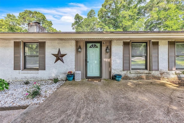 211 Murfee Dr, Prattville, AL 36066 - doorway to property featuring brick siding and a chimney