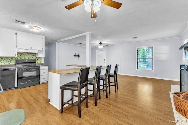 211 Murfee Dr, Prattville, AL 36066 - kitchen with black appliances, ceiling fan, under cabinet range hood, a textured ceiling, and light wood-style flooring