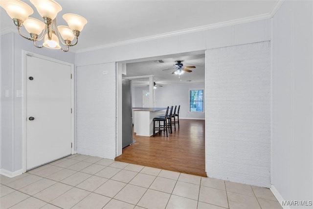 211 Murfee Dr, Prattville, AL 36066 - dining area featuring light tile patterned floors, a chandelier, a ceiling fan, and crown molding