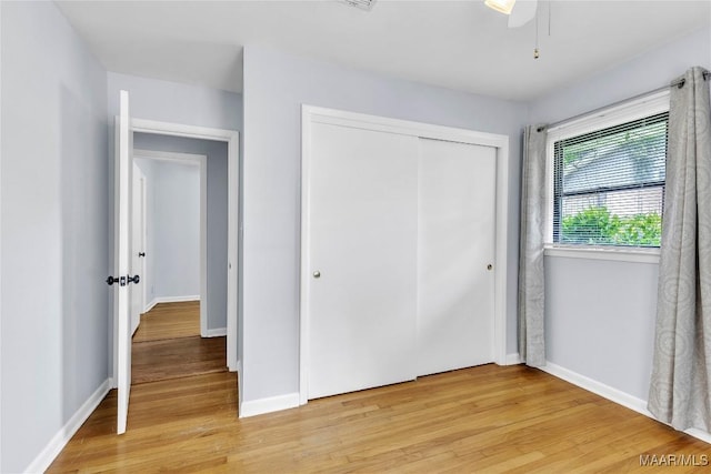 211 Murfee Dr, Prattville, AL 36066 - unfurnished bedroom with light wood-type flooring, a closet, baseboards, and a ceiling fan