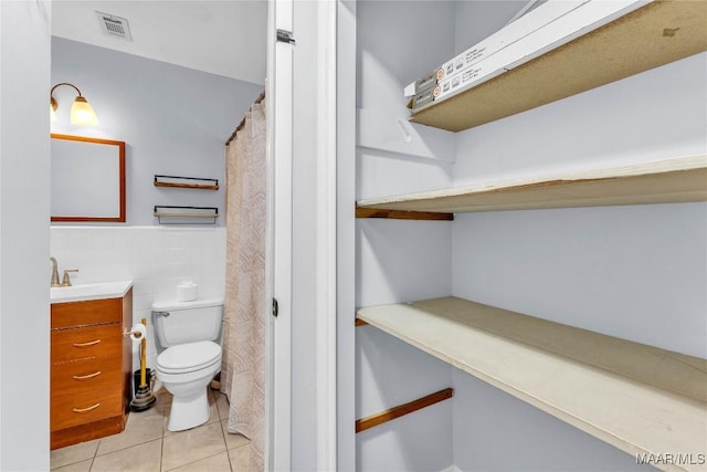 211 Murfee Dr, Prattville, AL 36066 - bathroom featuring tile walls, toilet, tile patterned flooring, and vanity