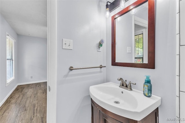 211 Murfee Dr, Prattville, AL 36066 - bathroom featuring vanity, wood finished floors, and baseboards