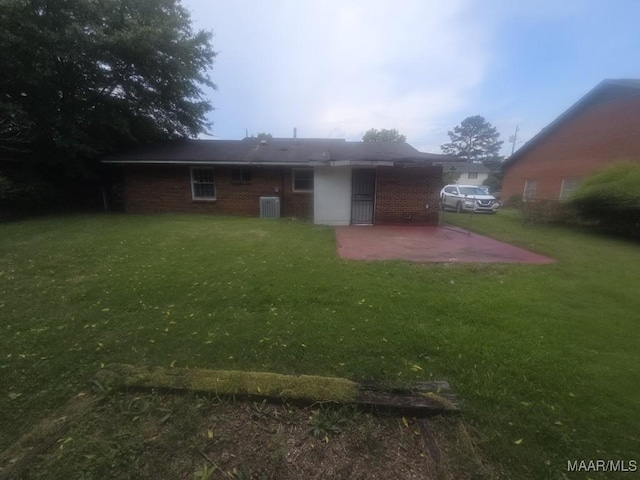 2930 Milton Rd, Montgomery, AL 36110 - back of house with a patio, a yard, brick siding, and central AC unit