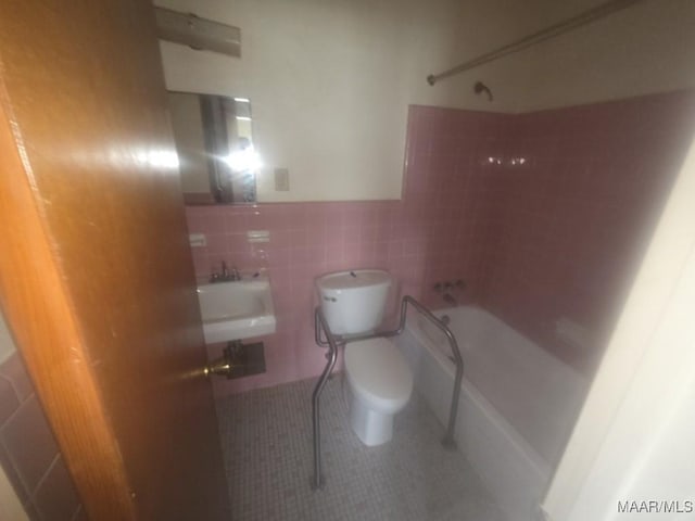 2930 Milton Rd, Montgomery, AL 36110 - full bathroom featuring  shower combination, toilet, tile walls, tile patterned floors, and a sink