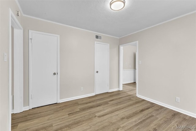 3556 Prince George Dr, Montgomery, AL 36109 - unfurnished bedroom with wood finished floors, crown molding, and baseboards