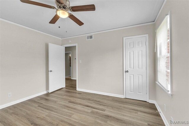 3556 Prince George Dr, Montgomery, AL 36109 - unfurnished bedroom featuring ornamental molding, light wood-style flooring, baseboards, and a ceiling fan