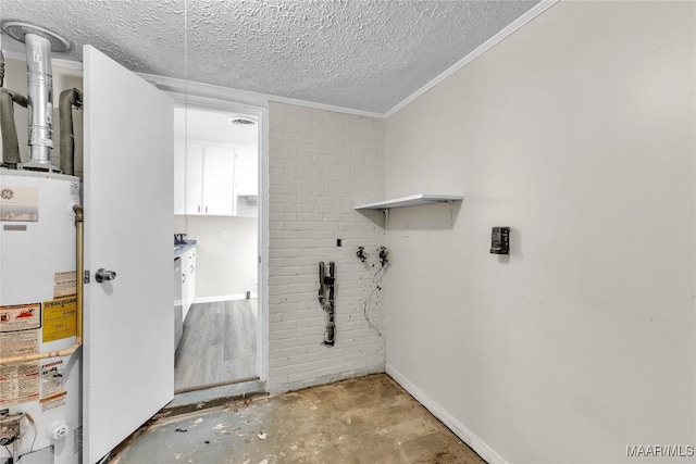 3556 Prince George Dr, Montgomery, AL 36109 - laundry area with water heater, a textured ceiling, baseboards, and crown molding