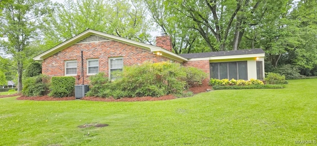 2728 Oxford Dr, Montgomery, AL 36111 - view of side of home featuring brick siding, a chimney, and a yard