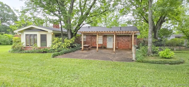 2728 Oxford Dr, Montgomery, AL 36111 - rear view of house featuring a yard, a patio area, and brick siding
