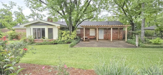 2728 Oxford Dr, Montgomery, AL 36111 - back of house featuring a patio area, brick siding, a yard, and a chimney